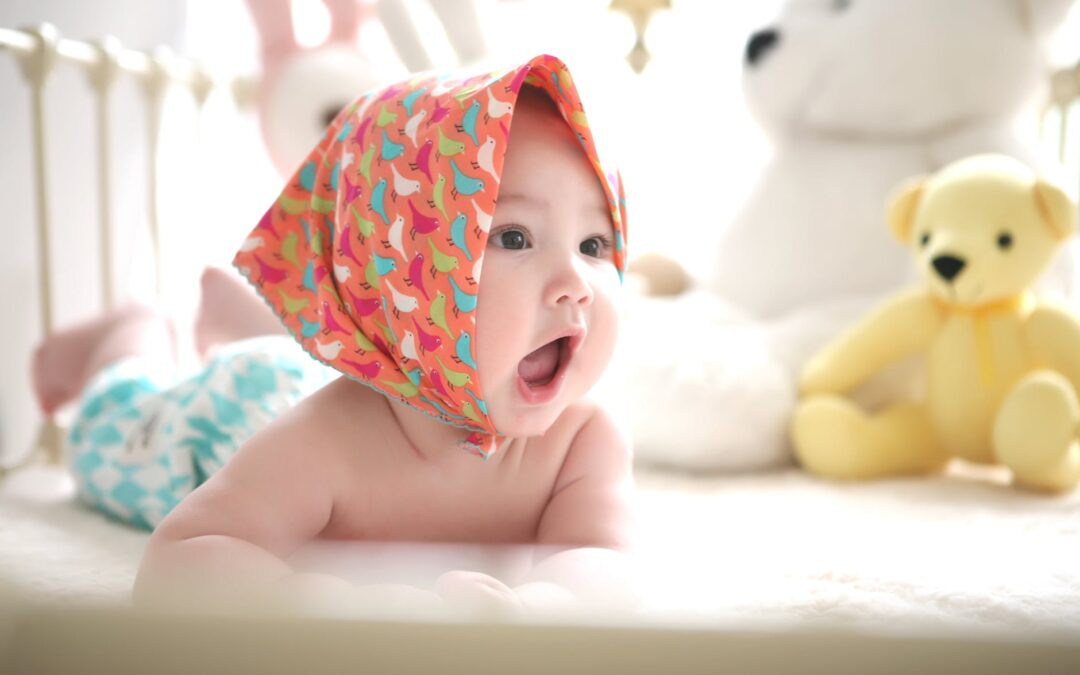 toddler wearing head scarf in bed