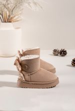 Side view of kids beige mini snuggle boots with textured sole and fluffy lining Side view of kids beige mini snuggle boots with textured sole and fluffy lining